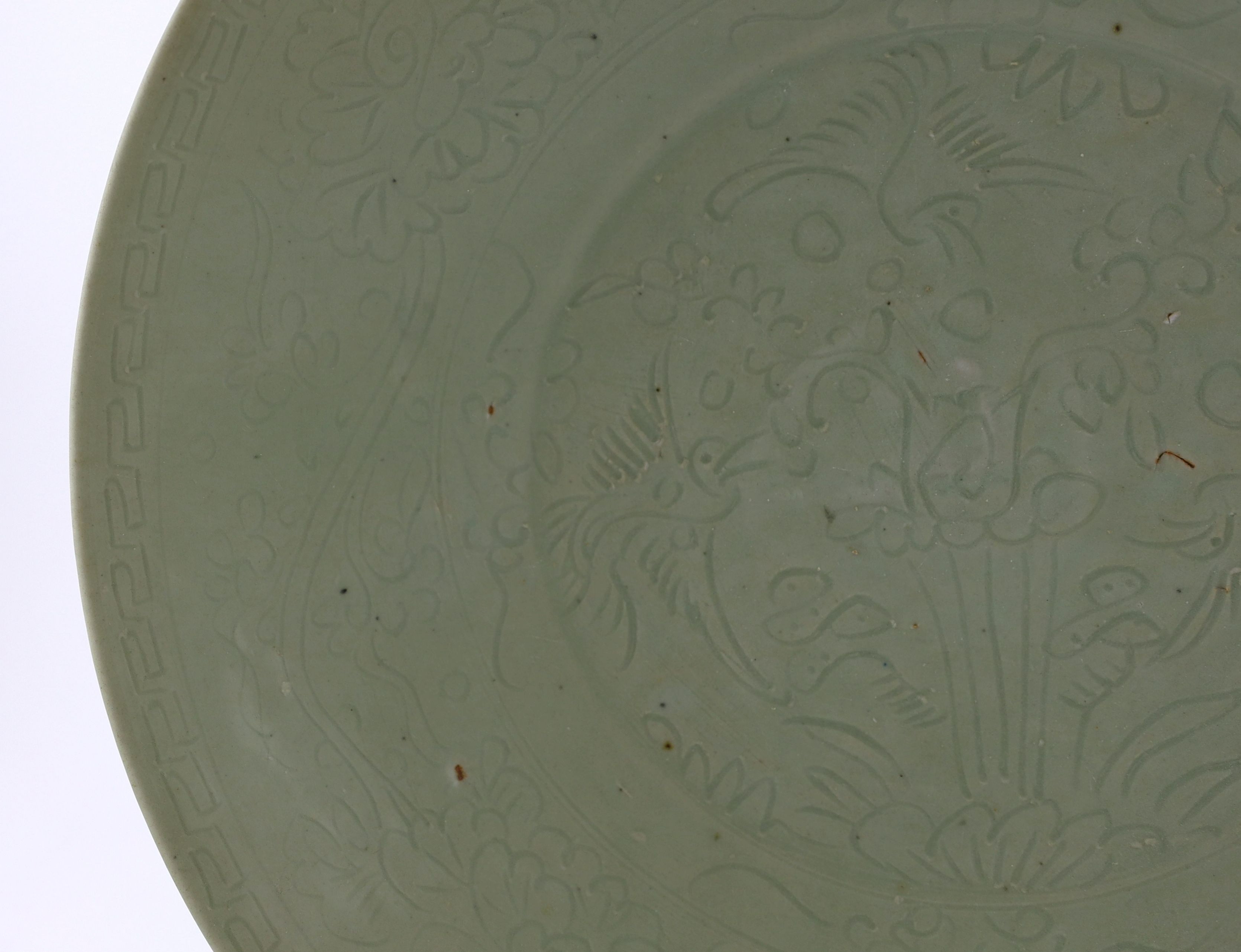 A Chinese celadon glazed sgraffito dish, Zhangzhou kilns, late 16th/early 17th century, 37cm diameter